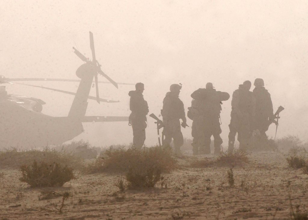 A group of US combat soldiers prepare to board a US Army Blackhawk helicopter for a mission in Karbala 03 April 2003, one day after US forces from the 3rd Infantry Division seized the strategic Karbala pass from Iraq's Republican Guards. A US Army Blackhawk helicopter was shot down yesterday near the city of Karbala, south of Baghdad, but there were conflicting reports between the Pentagon and US Central Command (Centcom) in Qatar on the number aboard and the number dead. The Pentagon said the Blackhawk was apparently downed by small arms fire while Centcom said it was on  "an operational mission" when it crashed.  AFP PHOTO/Romeo GACAD