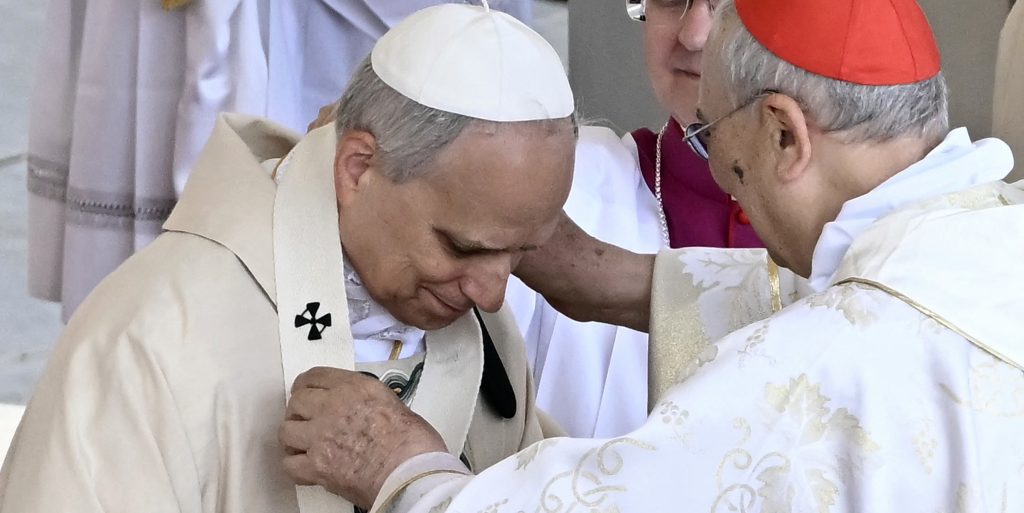 Pope Leo XIV receives the pallium by Moroccan Cardinal Dominique Mamberti during a mass for the beginning of his pontificate, in St Peter's square in The Vatican on May 18, 2025.  (Photo by Filippo MONTEFORTE / AFP)